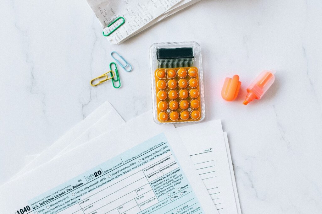 Documents on a table beside a calculator.